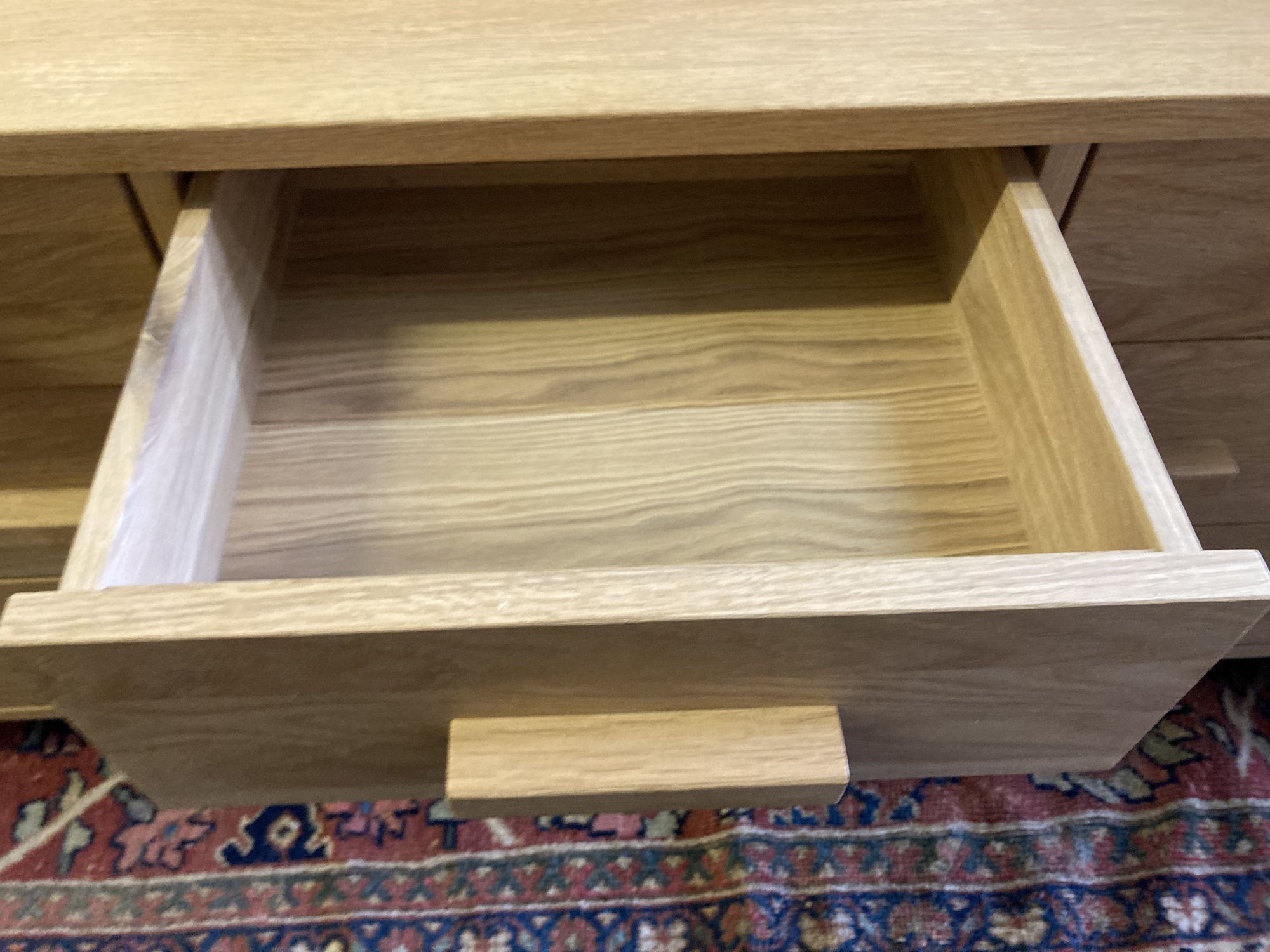 A modern contemporary oak seven-drawer chest, width 150cm, depth 45cm, height 71cm